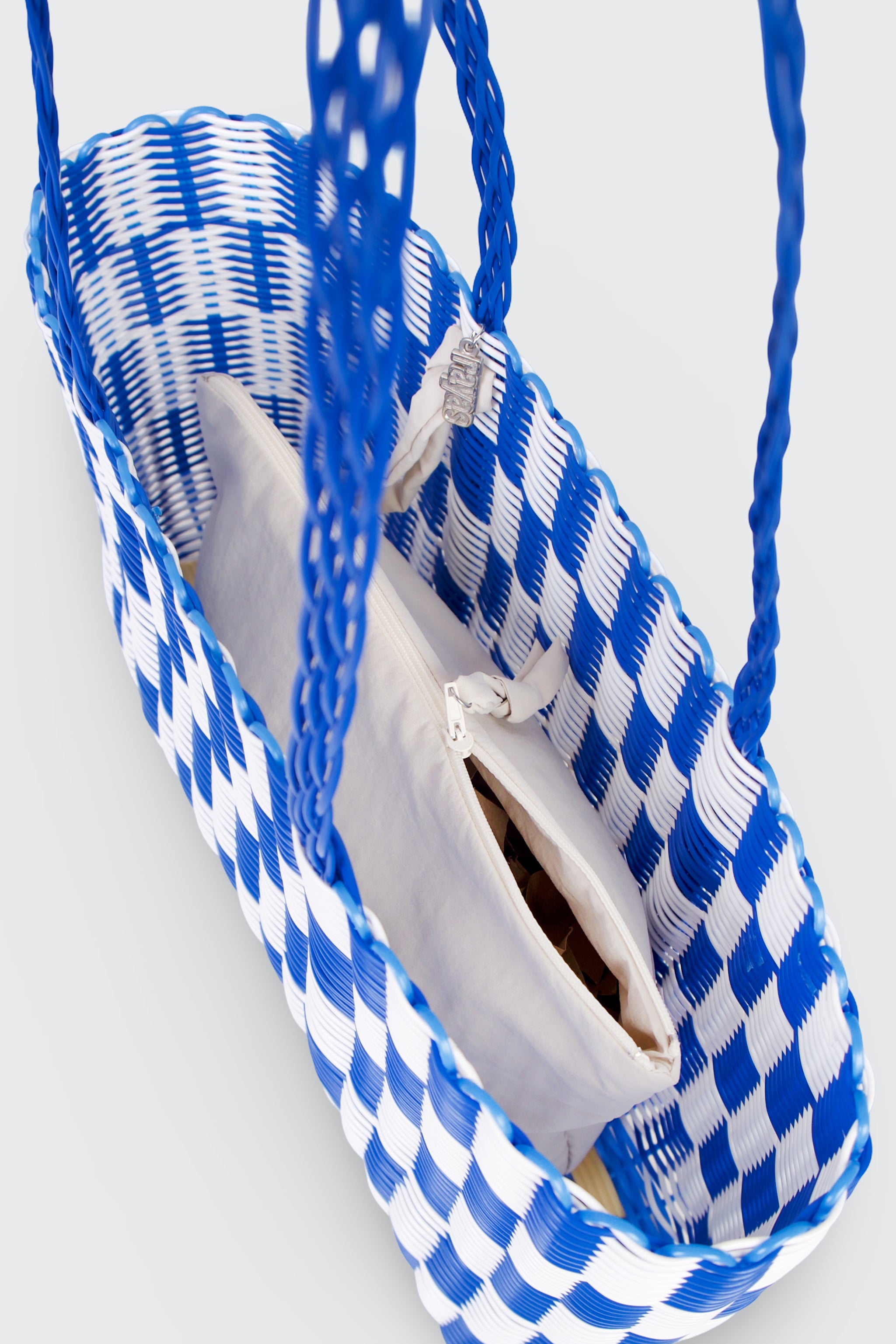 Blue and white checkered basket bag with a white inlay bag on a light gray background